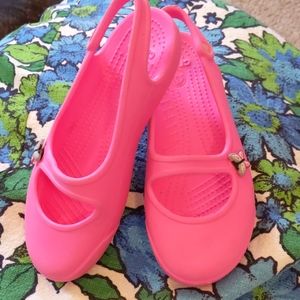Bright pink crocs with butterfly